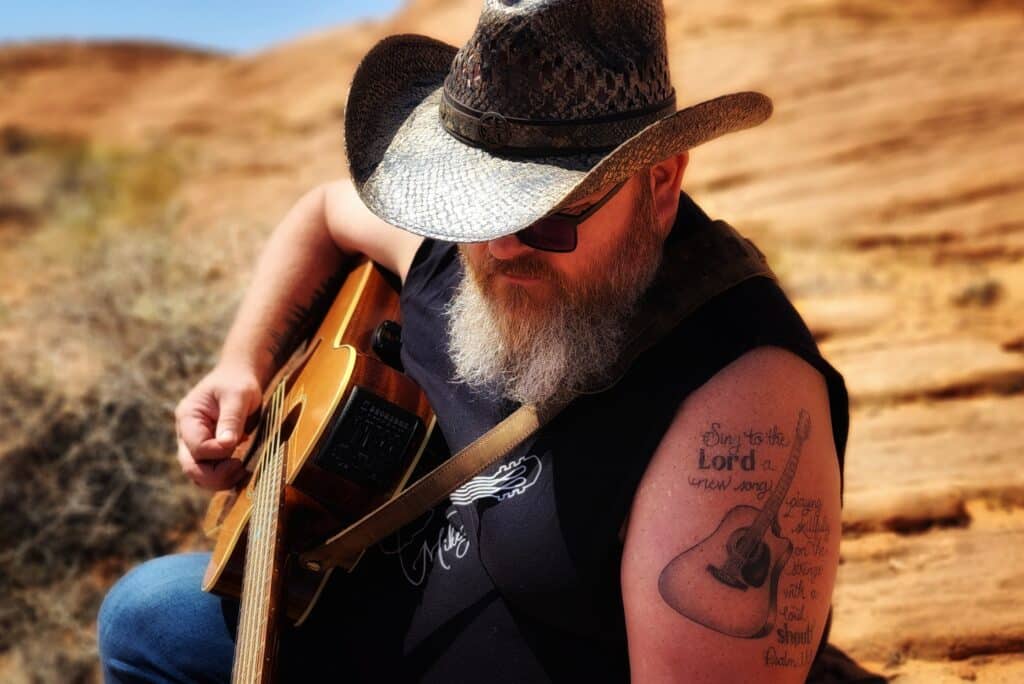 Mikey Goode playing a guitar